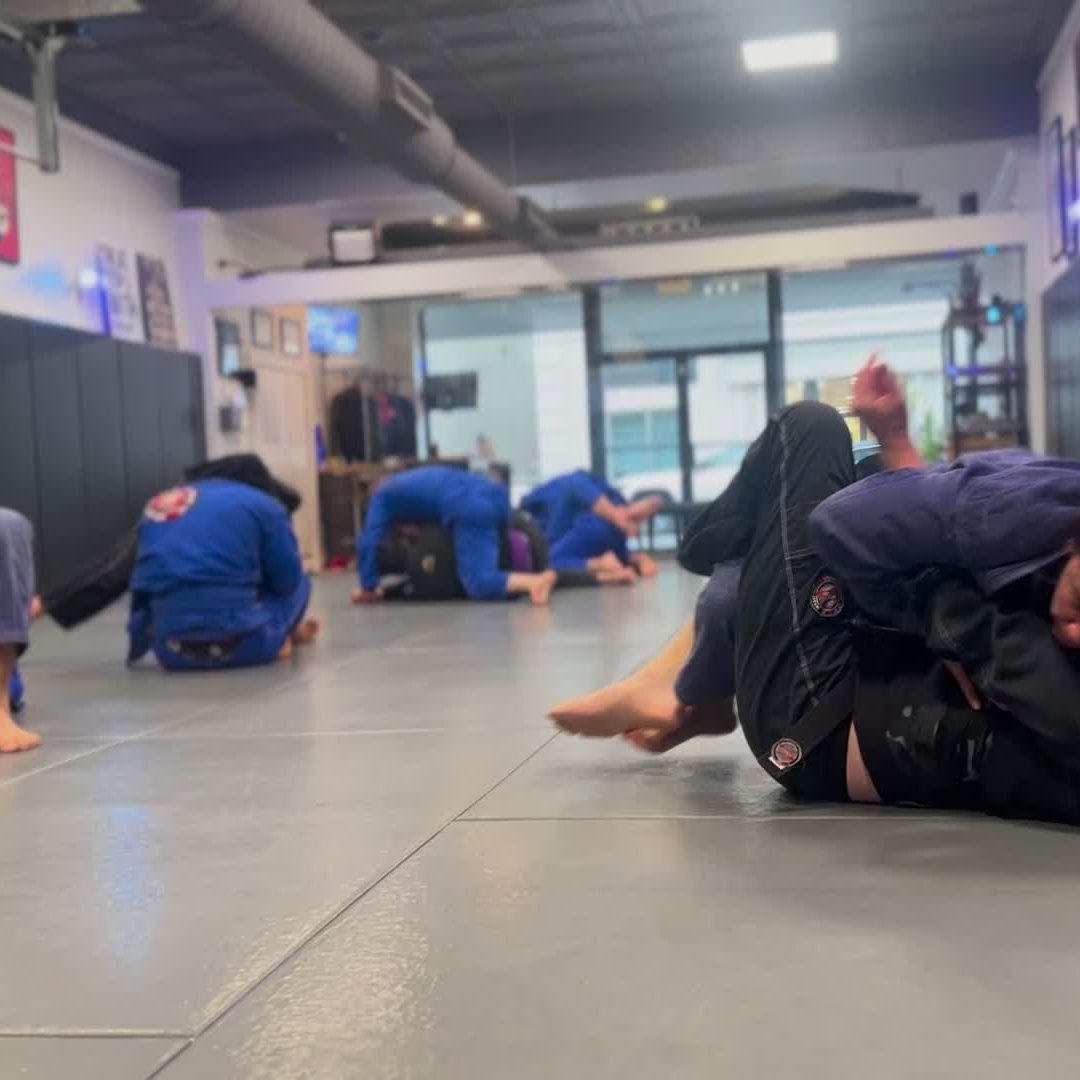 Adults rolling live during class at Soca BJJ Glen Cove
