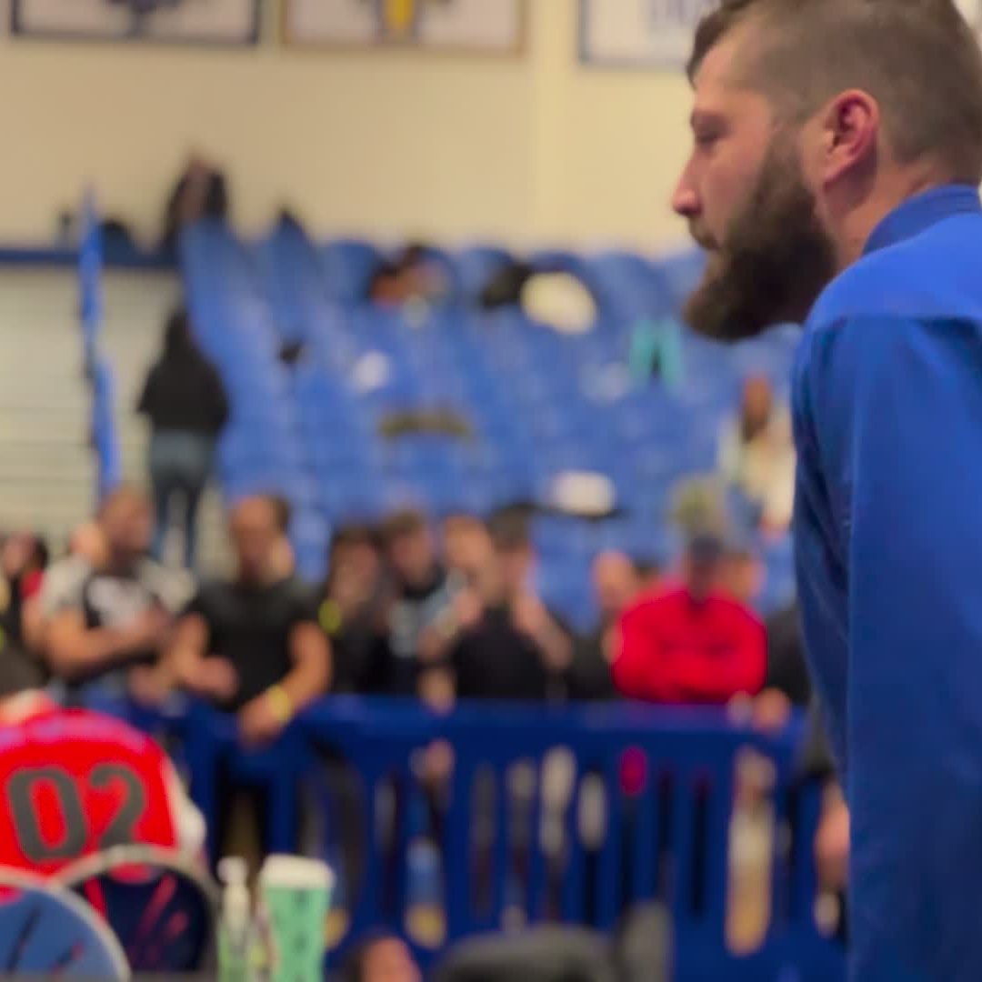 A Soca competitor in his gi at a Brazilian Jiu-Jitsu tournament