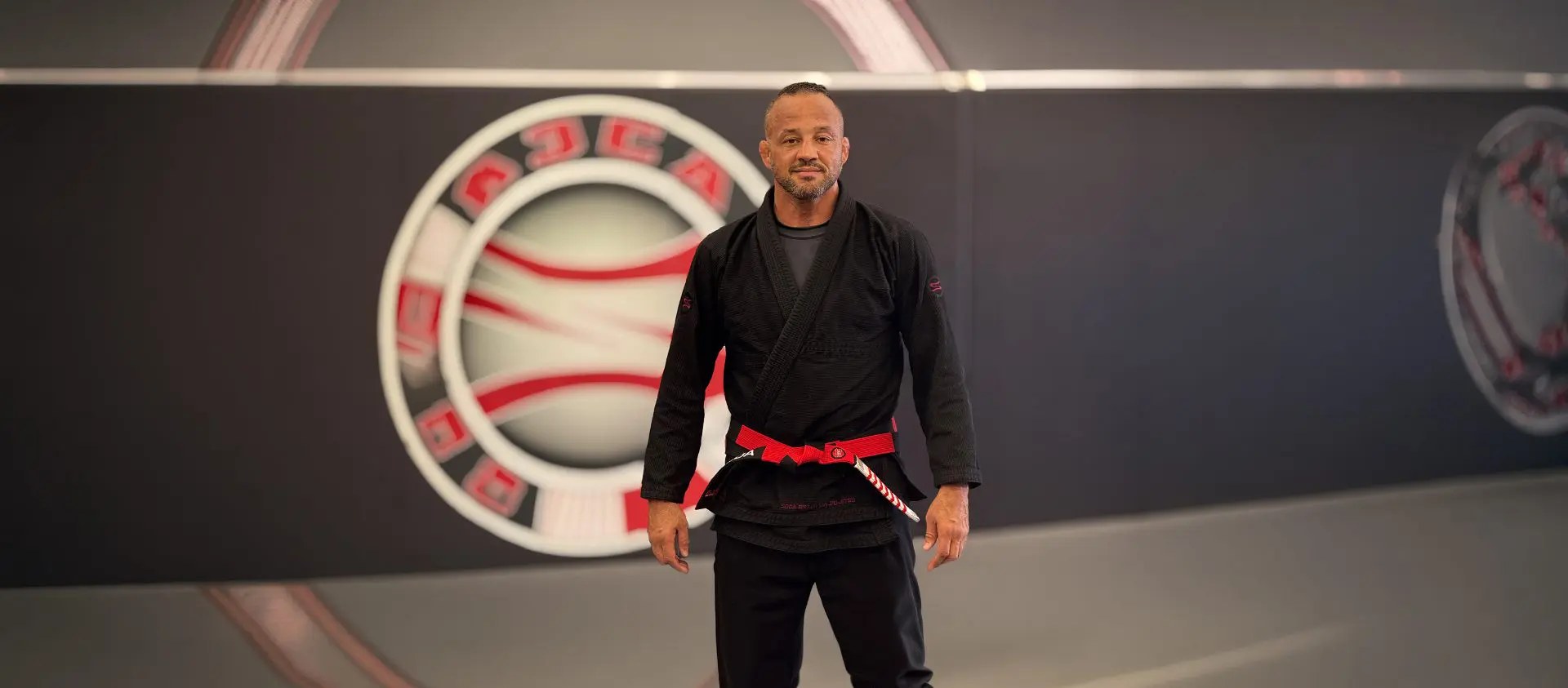 Master Alexandre Soca Freitas — Master Soca in his 7th-degree coral belt at the Soca BJJ headquarters