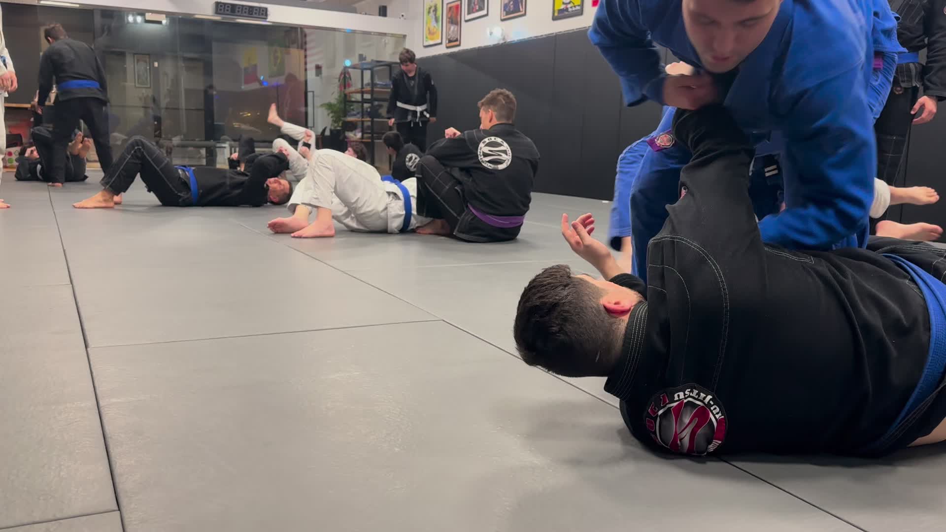 Adults rolling during class at Soca BJJ Glen Cove